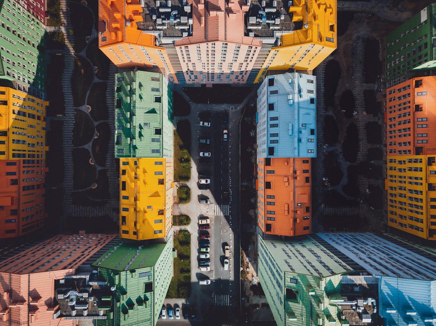 Colorful modern buildings with flat roofs seen from above.